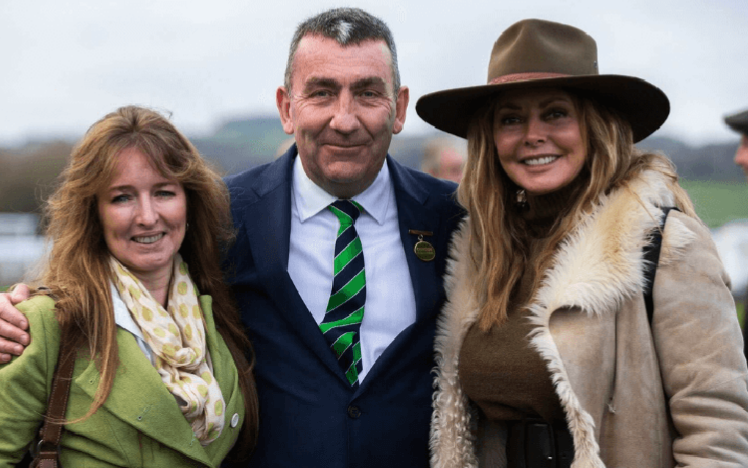 A picture of Carol Vordeman and associate with management of Chepstow Racecourse