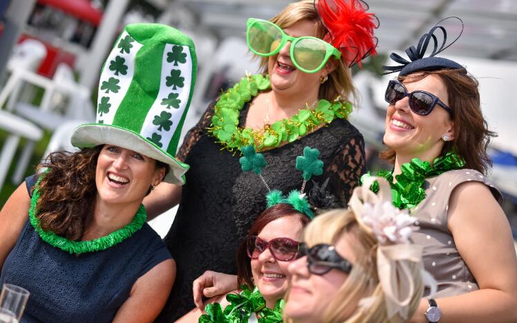 A group of race goers dressed up in green fancy dress for St Patricks Day.